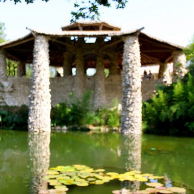 pond out of focus with pillars and green water